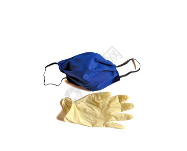 白色背景上的蓝色手工医疗面具和白乳胶手套图片