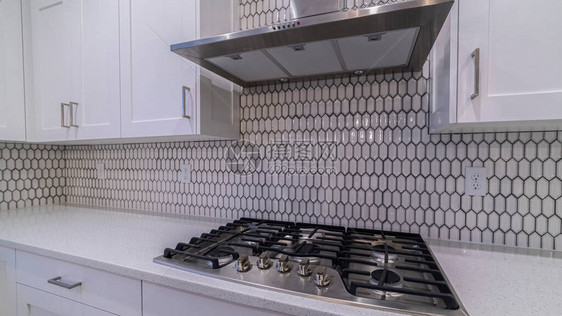 全景框架现代燃气炊具和提取器风扇在装配的白色厨房里图片