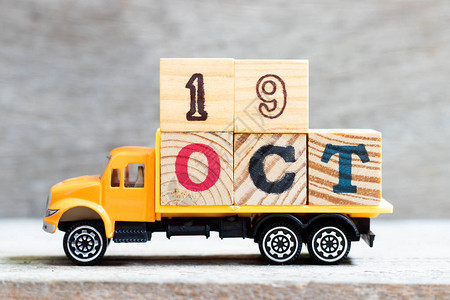 木材背景上的卡车持有19oct字的母块设想日期为1图片