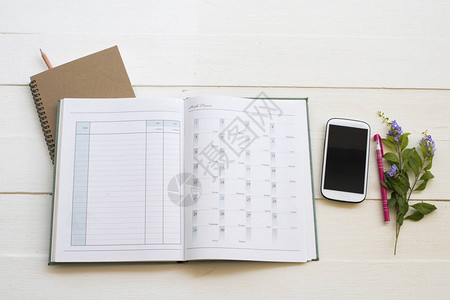 年度计划用于商务工作安排的笔记本帐户规划器和手机背景