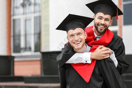 在户外穿着学士袍的年轻学生图片