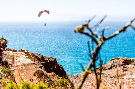 海景海岸陡峭有岩石和降落伞跳图片