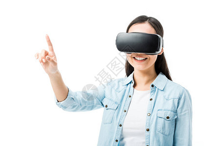 穿着戴尼姆衬衫的笑着女人带着虚拟现实耳机用图片