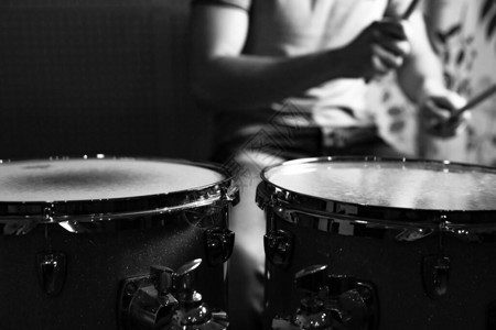 鼓手用鼓槌敲鼓特写照片专注于鼓图片