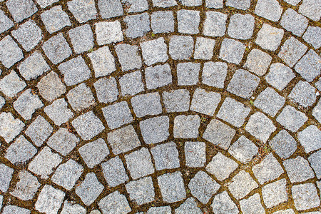 花岗岩石的铺面古老的cobblestone路面结构石块之间的抽象背图片