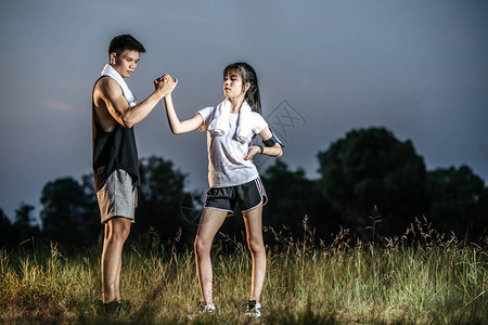 女人和男人手牵站着锻炼图片