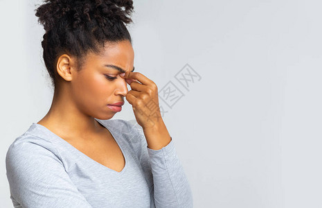 疲惫的非洲女人摸着鼻梁眼痛眼睛疲图片