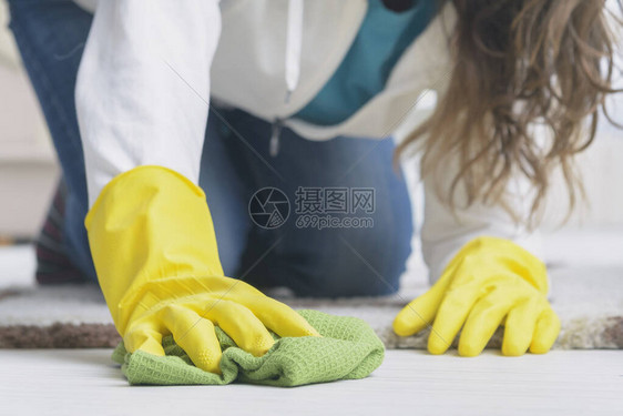 妇女穿着黄色橡胶手套在家图片