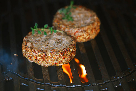 用薄荷和羊肉调味的羊肉汉堡在烧烤架上用火焰摩擦图片