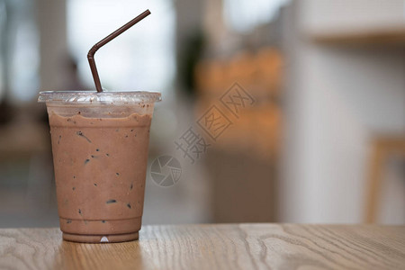 咖啡店木桌上的外卖杯冰咖啡摩卡咖啡美味又提背景图片