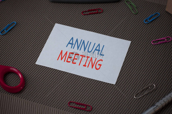 手写文字书写年会组织一般成员的概念照片年度会议剪刀和书写设备加上纹理背景图片