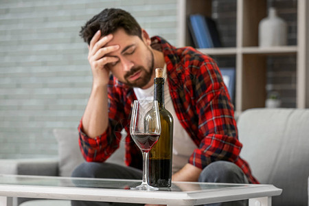 男人在家里喝酒酗酒的概图片