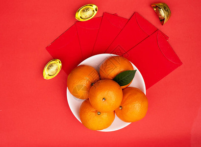 农历新年和农历新年假期概念背景的配饰白盘中的橙色图片