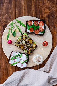 三明治放在木板上红菜鳄梨蘑菇番茄菠菜图片