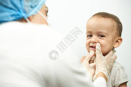 儿科医生检查婴儿牙齿牙医检背景图片