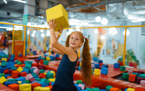 可爱的小女孩玩软立方体在娱乐中心操场玩耍室内游图片