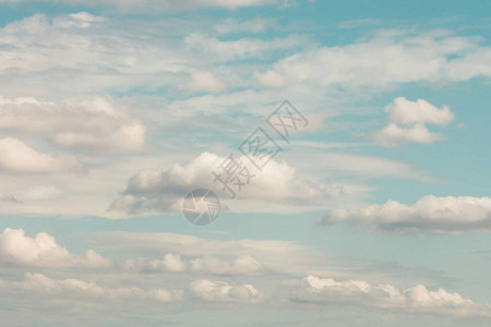 在淡蓝色柔和的天空上形成柔和的白云背景图片