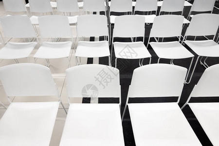 用于正式会议会议讲座毕业典礼的一排白色塑料椅子房间里摆满了空荡背景图片