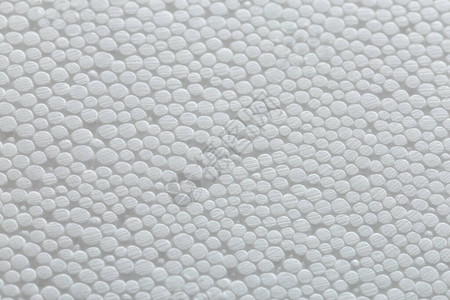 白色聚苯乙烯泡沫或聚苯乙烯泡沫塑料的简单特写平坦但凹凸不平的背景背景图片