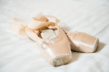 白床上的足尖芭蕾舞鞋图片
