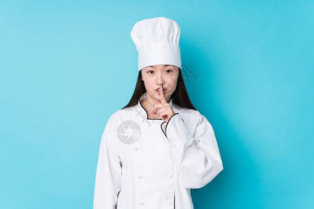 年轻的厨师女厨师孤立地保守秘密或图片