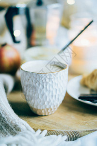 漂亮的白手工制陶瓷杯在真正的室图片