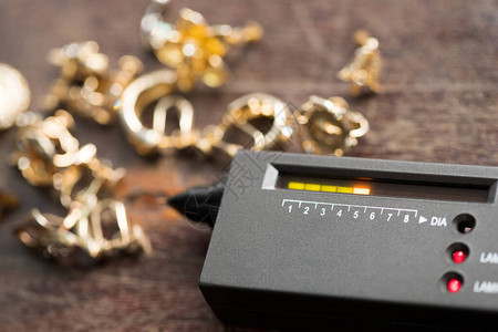 许多昂贵的装饰戒指耳环准备好用钻石测试仪检查真假宝石选择器宝石LED指示灯珠宝套件测试便携式电子设备可快背景图片