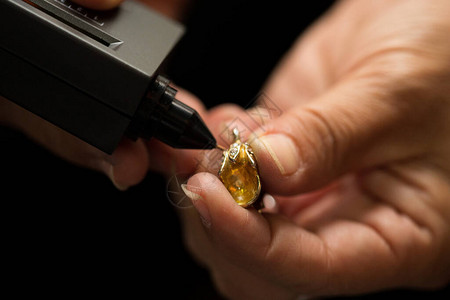 手中的金戒指准备好用钻石测试仪宝石选择器宝石LED指示灯珠宝套件测试检查真假图片