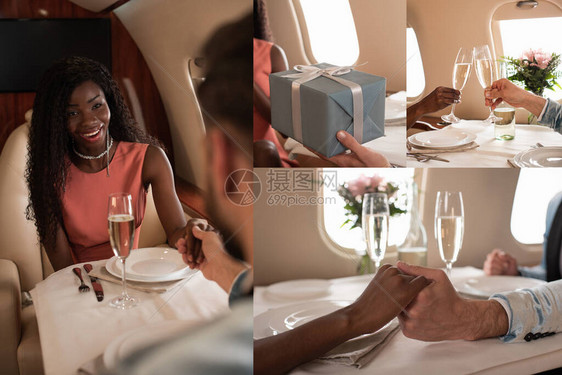 快乐的跨种族夫妇手牵着手香槟杯碰和男人在飞机上向非洲裔美国妇女赠送图片