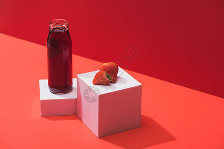 红底立方体上接近成熟草莓的玻璃图片