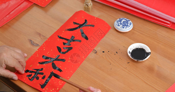 写中文书法的老男人意味着运气好新年图片