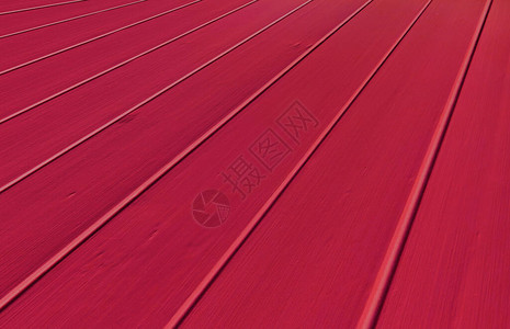 用作背景或设计元素的红色木地板的特写图片