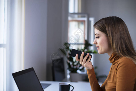 年轻女士在办公室的电话中背景图片