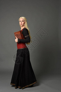 穿着红色和黑色幻想中世纪长袍的金发美女全长肖像在灰色背图片