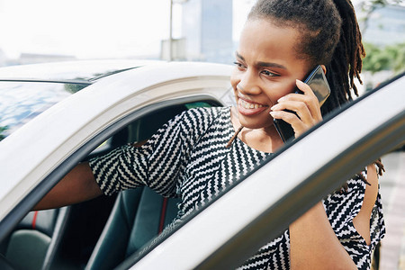 非洲青年女商人坐在城里的汽车里图片