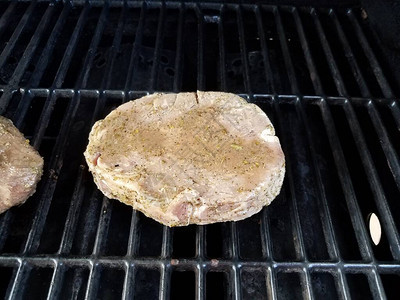 生猪肉在烤肉架上烹饪调味料图片