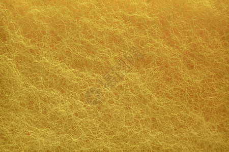 紧贴的黄色海绵背景纹理宏观摄影视图片