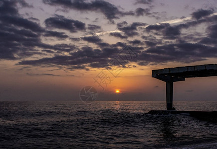 海景和多云的天空日落时有太阳自然背景图片