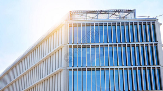 办公楼窗户的底视图与日出反射和透视密切相关现代建筑与太阳光线玻璃幕墙在阳光明媚的日子里图片