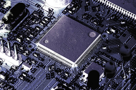电子PCB印刷电路板与晶体管电路和电子硬件元的宏观特写背景图片