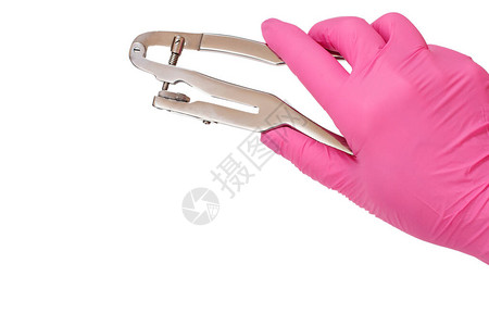 牙科医生用粉色乳胶手套的手在白色隔缝背景上打牙拳图片