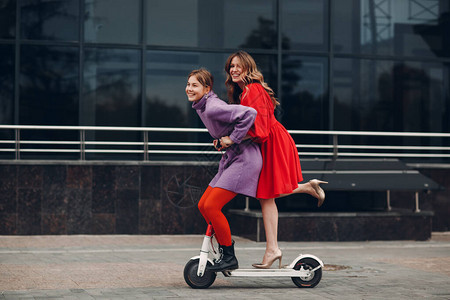 在城里骑电动滑板车的年轻女人图片
