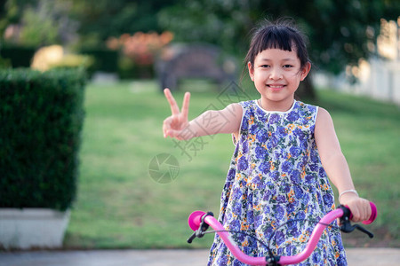 亚裔女孩带着微笑和快乐的笑容骑图片