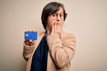年轻的唐氏综合症女商人拿着信用卡作为客户付款图片