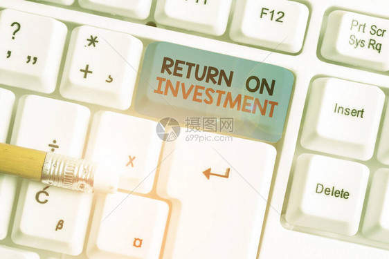 显示投资回报的书面说明净利润与成本投资比率的商业概念白色pc键盘与白色背景图片