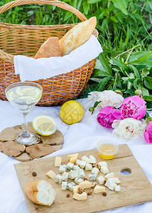 在草地上野餐奶酪法式面包柠檬淡水和篮子特写图片