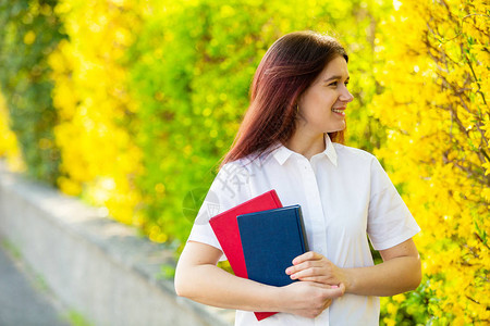 校园里户外女大学生的微笑肖像图片