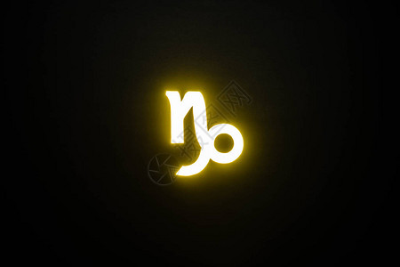 黄色发光的摩羯座星在黑色上隔离背景图片
