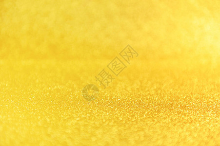金色亮片关闭背景闪发光的黄色散焦背景迷人的金色沙粒背景图片