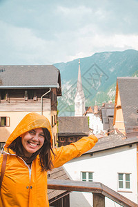 年轻微笑的女士在黄雨衣中的肖像在哈利斯特城图片